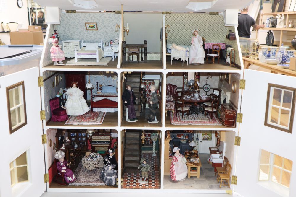 A modern Victorian style dolls house with antique and other furniture and contents including dolls, jointed miniature dolls